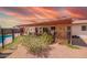 Inviting pool area with lush landscaping, covered patio, and charming trellis at 809 N 95Th St, Mesa, AZ 85207