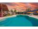 Inviting pool area with mural wall and lush desert landscaping perfect for relaxation at 809 N 95Th St, Mesa, AZ 85207