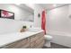 Bright bathroom featuring a modern vanity with a vessel sink, a large mirror, and a shower-tub combo at 8754 E Via De Sereno --, Scottsdale, AZ 85258