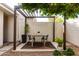 Charming outdoor dining area featuring a pergola, perfect for enjoying meals in a serene backyard setting at 8754 E Via De Sereno --, Scottsdale, AZ 85258