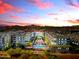 Beautiful aerial view of the condo complex with a pool and gorgeous sunset in the background at 945 E Playa Del Norte Dr # 4017, Tempe, AZ 85288