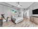 Spacious bedroom with wood floors, soft blue accents and a modern platform bed at 945 E Playa Del Norte Dr # 4017, Tempe, AZ 85288