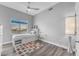 Serene bedroom featuring a cozy bed with built-in storage, complemented by a ceiling fan and ample natural light at 945 E Playa Del Norte Dr # 4017, Tempe, AZ 85288