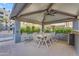 Covered outdoor dining area with a large table, chairs, and ceiling fan at 945 E Playa Del Norte Dr # 4017, Tempe, AZ 85288