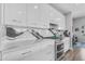 Bright kitchen boasts a gas range, glossy cabinets, and artistic marble-style backsplash at 945 E Playa Del Norte Dr # 4017, Tempe, AZ 85288