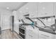 Modern kitchen with white cabinets, granite countertops, and stainless steel appliances at 945 E Playa Del Norte Dr # 4017, Tempe, AZ 85288