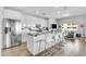 Modern kitchen featuring an island with barstool seating, stainless appliances and designer backsplash at 945 E Playa Del Norte Dr # 4017, Tempe, AZ 85288