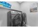 Functional laundry area showcasing modern Samsung washer and dryer units with overhead storage space at 945 E Playa Del Norte Dr # 4017, Tempe, AZ 85288
