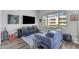 Modern living room boasts sleek furniture, entertainment center, and ample natural light from the large window at 945 E Playa Del Norte Dr # 4017, Tempe, AZ 85288