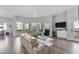 Bright living room featuring modern furnishings, wood floors, and a wall of windows with city views at 945 E Playa Del Norte Dr # 4017, Tempe, AZ 85288