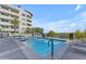 Community pool with lake views, waterfall features, and lounge chairs on the deck at 945 E Playa Del Norte Dr # 4017, Tempe, AZ 85288
