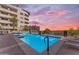 Resort-style pool and spa with a serene ambiance and beautifully landscaped surroundings at sunset at 945 E Playa Del Norte Dr # 4017, Tempe, AZ 85288