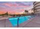 Relaxing pool area with crystal-clear water, palm trees, and comfortable lounge chairs, perfect for a summer retreat at 945 E Playa Del Norte Dr # 4017, Tempe, AZ 85288