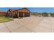Wide driveway leading to a well-maintained home with a two-car garage at 9625 W Prospector Dr, Queen Creek, AZ 85144
