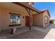 Welcoming front entrance featuring a covered porch and a red front door at 9625 W Prospector Dr, Queen Creek, AZ 85144