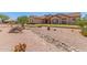 Charming home with desert landscaping, rock accents, and a well-maintained front yard at 9625 W Prospector Dr, Queen Creek, AZ 85144