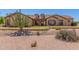 Charming single-story home featuring desert landscaping, a red front door, and dormer windows at 9625 W Prospector Dr, Queen Creek, AZ 85144