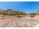 Inviting single-story home with desert landscaping, rock accents, and a tiled roof at 9625 W Prospector Dr, Queen Creek, AZ 85144
