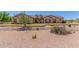 Charming single-story home featuring desert landscaping, a red front door, and dormer windows at 9625 W Prospector Dr, Queen Creek, AZ 85144