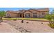 Charming home with desert landscaping, rock accents, and a well-maintained front yard at 9625 W Prospector Dr, Queen Creek, AZ 85144