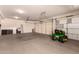 A large garage features a John Deere riding mower at 9625 W Prospector Dr, Queen Creek, AZ 85144