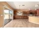 Spacious kitchen with tile floors, wooden cabinets, granite countertops, and stainless steel appliances at 9625 W Prospector Dr, Queen Creek, AZ 85144