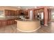 Spacious kitchen with large island, stainless steel appliances, granite countertops, and wooden cabinets at 9625 W Prospector Dr, Queen Creek, AZ 85144