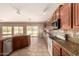 Beautiful kitchen with stainless steel appliances, granite countertops, tile backsplash, and access to the backyard at 9625 W Prospector Dr, Queen Creek, AZ 85144