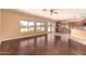 Bright living room with wood floors, large windows offering picturesque views, and seamless connection to the kitchen at 9625 W Prospector Dr, Queen Creek, AZ 85144