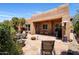 A Southwestern-style patio with a lounge area and a cozy fire pit for outdoor entertaining at 9653 E Sidewinder Trl, Scottsdale, AZ 85262