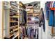 A walk-in closet featuring shelving, hanging rods, and storage solutions for shoes, clothing, and accessories at 9653 E Sidewinder Trl, Scottsdale, AZ 85262