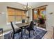 Cozy dining area with backyard views and a contemporary chandelier at 9653 E Sidewinder Trl, Scottsdale, AZ 85262
