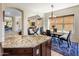 Bright dining area with a view to the living area and an island with granite countertops at 9653 E Sidewinder Trl, Scottsdale, AZ 85262