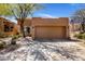Southwest-style home with a neutral-colored exterior, low-maintenance desert landscaping, and a spacious driveway at 9653 E Sidewinder Trl, Scottsdale, AZ 85262