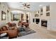 Bright living room with a fireplace, plush seating, and elegant decor at 9653 E Sidewinder Trl, Scottsdale, AZ 85262