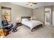 A beautiful bedroom with a comfortable leather chair, bedside lamps, and decorative glass block windows at 9653 E Sidewinder Trl, Scottsdale, AZ 85262