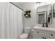 Bathroom featuring a shower, white vanity, mirror, and decorative shelving at 1029 E Marco Polo Rd, Phoenix, AZ 85024
