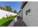 Private courtyard with lush green turf, mature landscaping, and outdoor seating at 1029 E Marco Polo Rd, Phoenix, AZ 85024