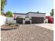 Inviting single-story home with gated front entry, desert landscaping, and a two-car garage at 1029 E Marco Polo Rd, Phoenix, AZ 85024
