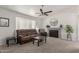 Bright living room with a large window, carpet flooring, a ceiling fan, and a cozy fireplace at 1029 E Marco Polo Rd, Phoenix, AZ 85024