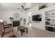 Cozy living room with a fireplace, carpet flooring, and neutral wall color at 1029 E Marco Polo Rd, Phoenix, AZ 85024