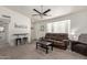 Inviting living room featuring a ceiling fan, carpet flooring, and ample natural light at 1029 E Marco Polo Rd, Phoenix, AZ 85024