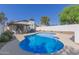 Backyard pool with a covered patio, well-maintained landscaping, and comfortable seating at 1029 E Marco Polo Rd, Phoenix, AZ 85024