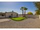 Beautiful backyard with synthetic putting green, mature palm trees, and gravel ground cover at 1064 S 97Th St, Mesa, AZ 85208