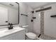 Modern bathroom features a tiled shower with stone accents and sleek, black fixtures at 1064 S 97Th St, Mesa, AZ 85208