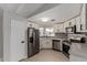 Well-lit kitchen features stainless steel appliances, mosaic tile backsplash, and bright white cabinets at 1064 S 97Th St, Mesa, AZ 85208
