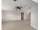 Spacious living room with modern gray-toned flooring, vaulted ceilings, and a modern ceiling fan at 1064 S 97Th St, Mesa, AZ 85208