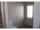 This bathroom features a toilet and small window, with white paneling and flooring at 11596 W Sierra Dawn Blvd # 286, Surprise, AZ 85378