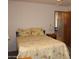 Cozy bedroom features a comfortable bed with floral patterned comforter, and bedside table at 11596 W Sierra Dawn Blvd # 286, Surprise, AZ 85378