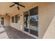 Covered patio area with stone pavers, ceiling fans and multiple windows/ sliding glass door at 1197 W Fir Tree Rd, Queen Creek, AZ 85140
